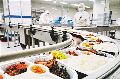 在北京京铁列车服务有限公司配餐基地，一份份高铁盒饭正源源不断从流水线上生产出来。本报记者 贺勇摄
